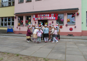 Dzieci tańczą z pióropuszami na głowach