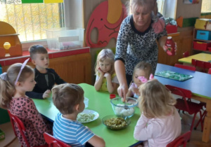 Dzieci z grupy "Biedronki" z pomocą Pani przygotowują sałatkę dla rodziców